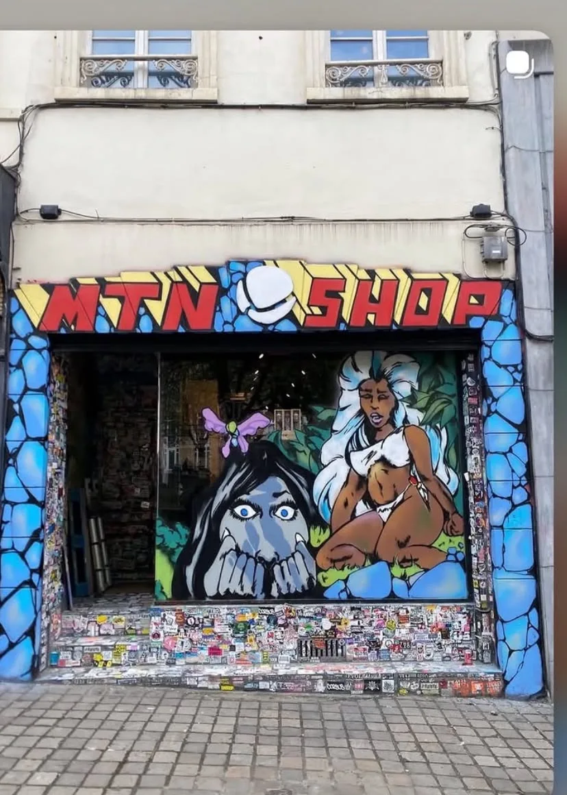 Painted MTN Shop frontage with colourful lettering and illustrated characters around the entrance